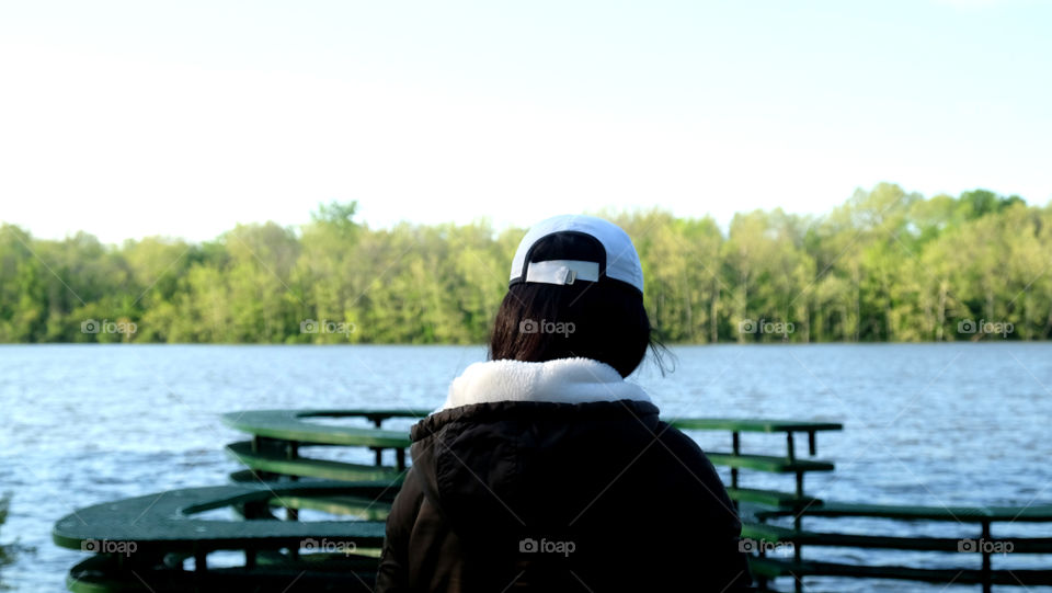 Back of a woman at a lake