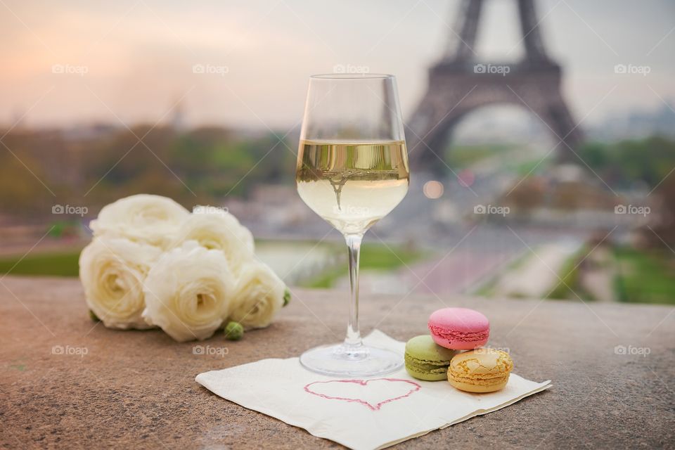 Wine glasses with croissant on the Eiffel Tower background 