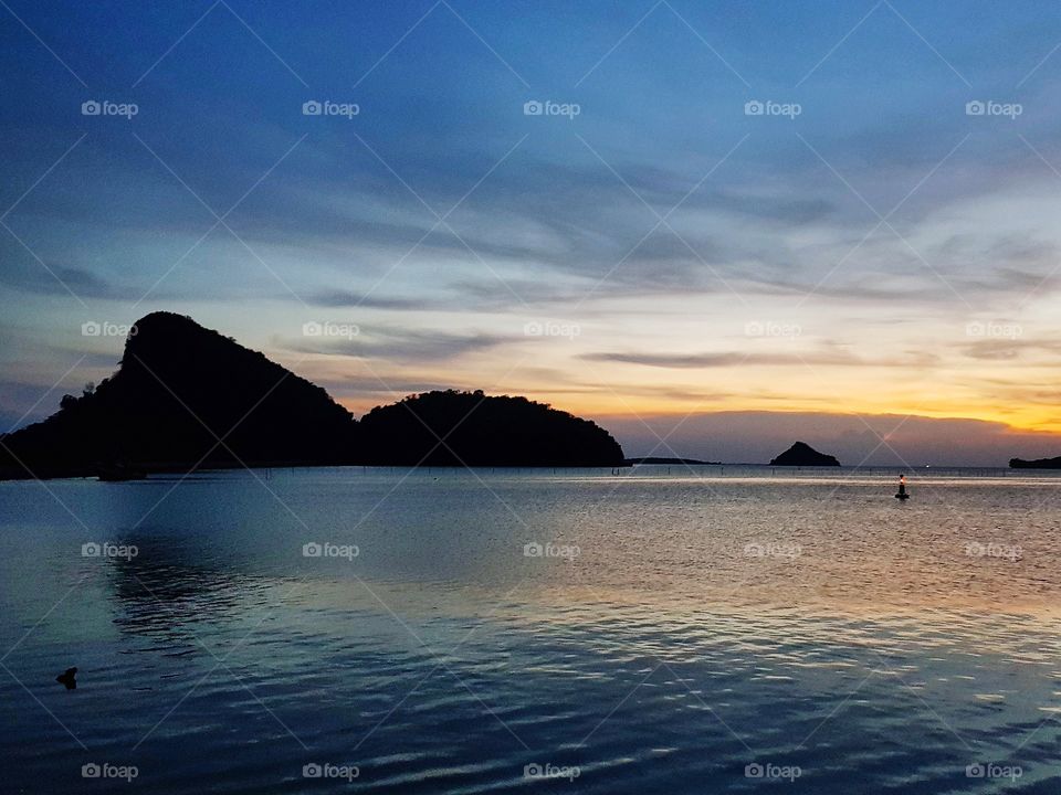 Scenic view of river against sunset sky