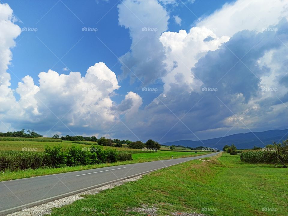 dark clouds above road