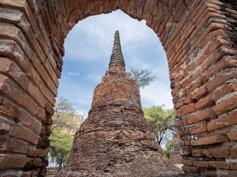 Thailand-June 25 2019:The pagoda at Wat Phra Si Sanphet in Ayuthaya have watched pass through window scene     