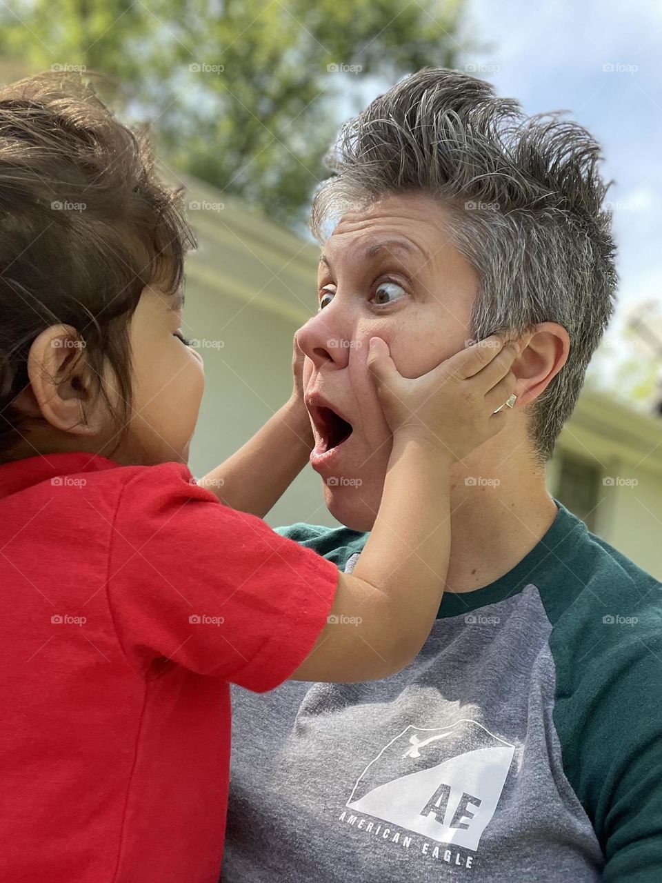 Toddler grabbing mother’s face, surprised mother and toddler, toddler surprises mother, funny surprised expressions, toddler surprises mommy, toddler puts hands on mommy’s face, facial expressions of surprise, mommy is surprised by toddler, fun times