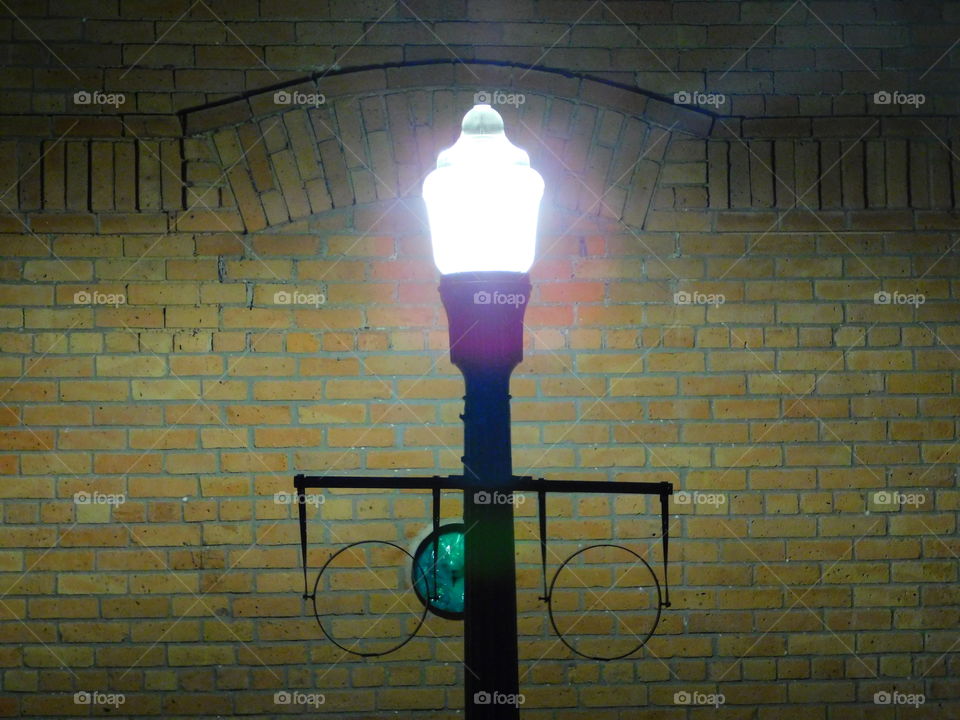 streetlamp by a brick building