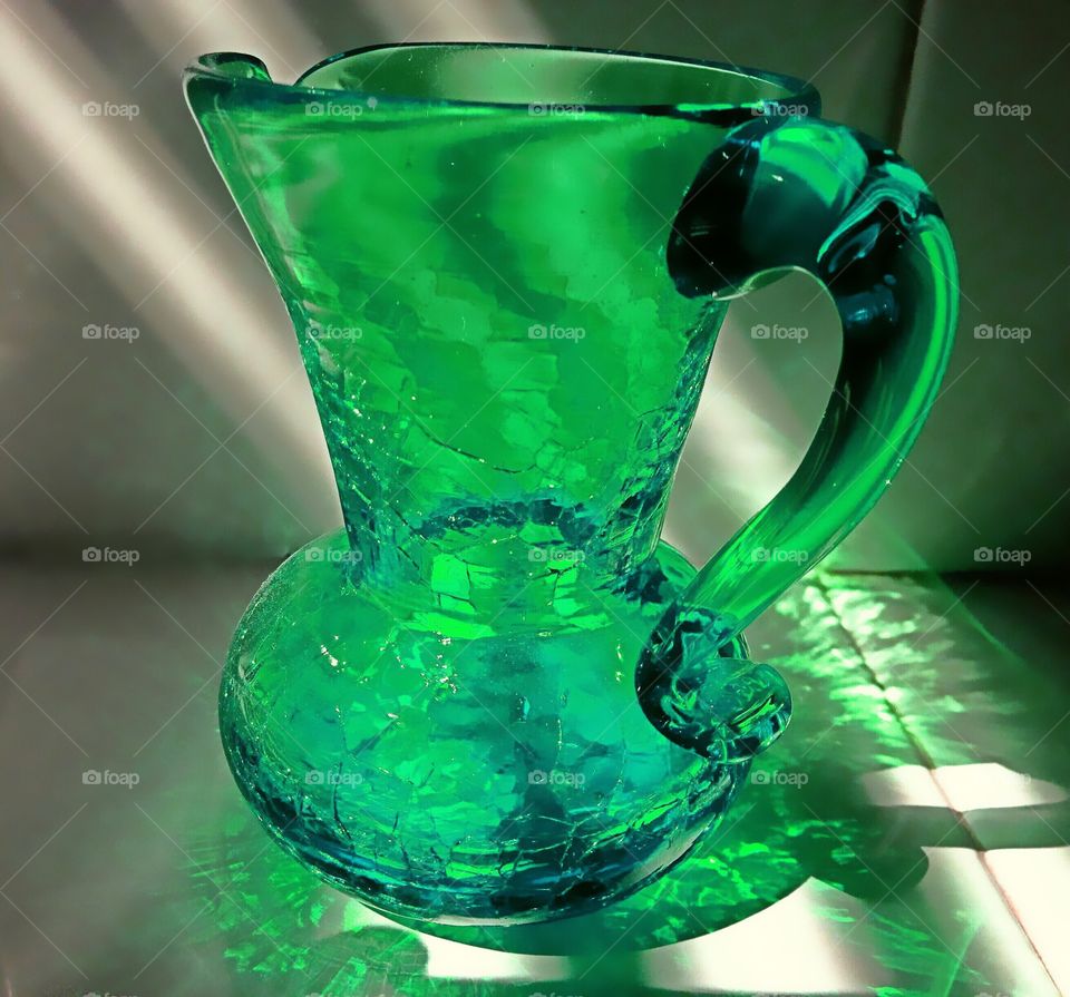 Green story-vase in light rays. 