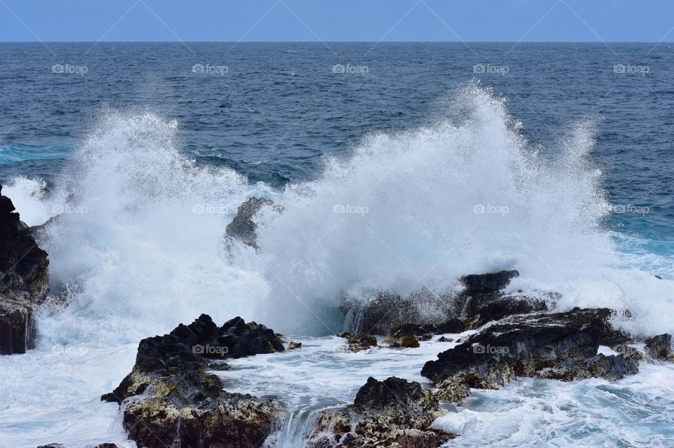 Big splash on an outcropping of lava rock on the Big Island of Hawaii