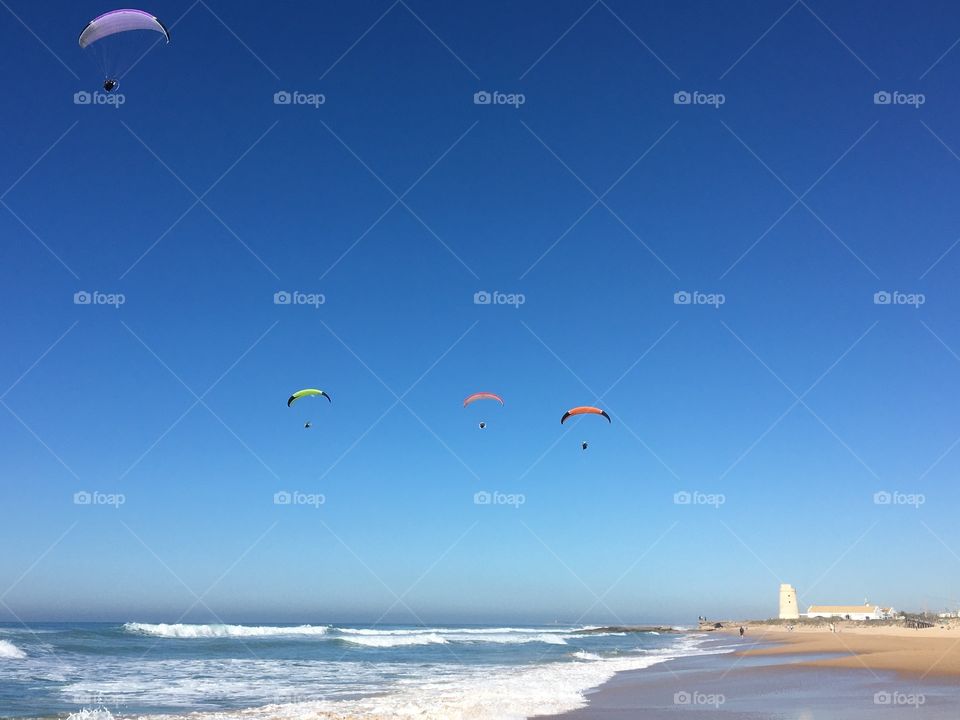 Paragliding over beach 