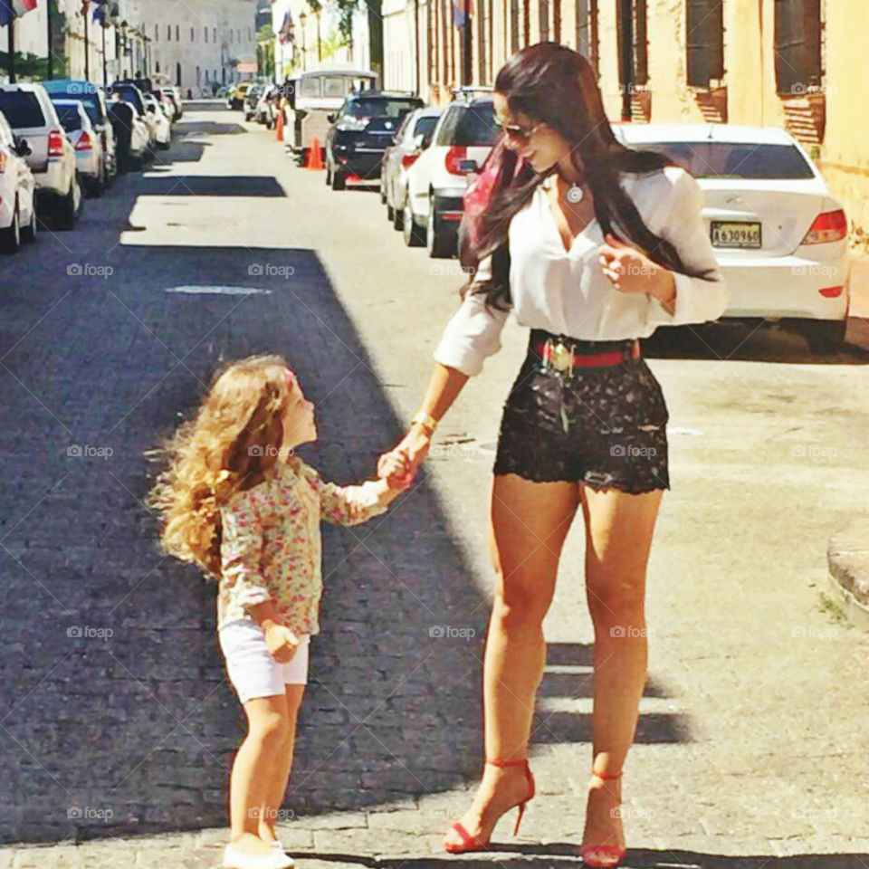 Mother walking on street with her daughter