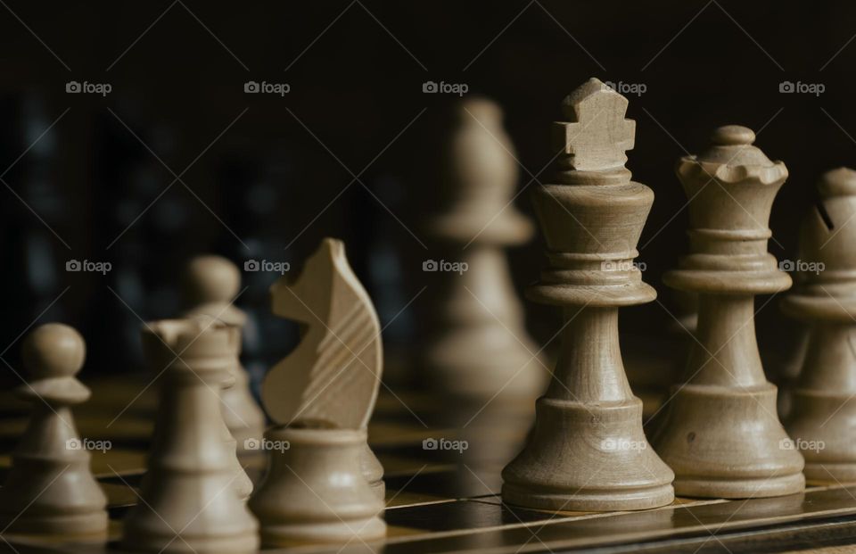 Close up of wooden chess pieces on a wood board