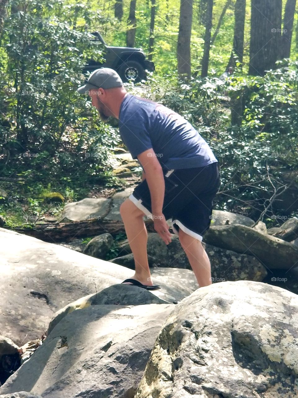 Up the massive rocks, active adventurous man of the woods of the Great Smoky Mountains National Park.