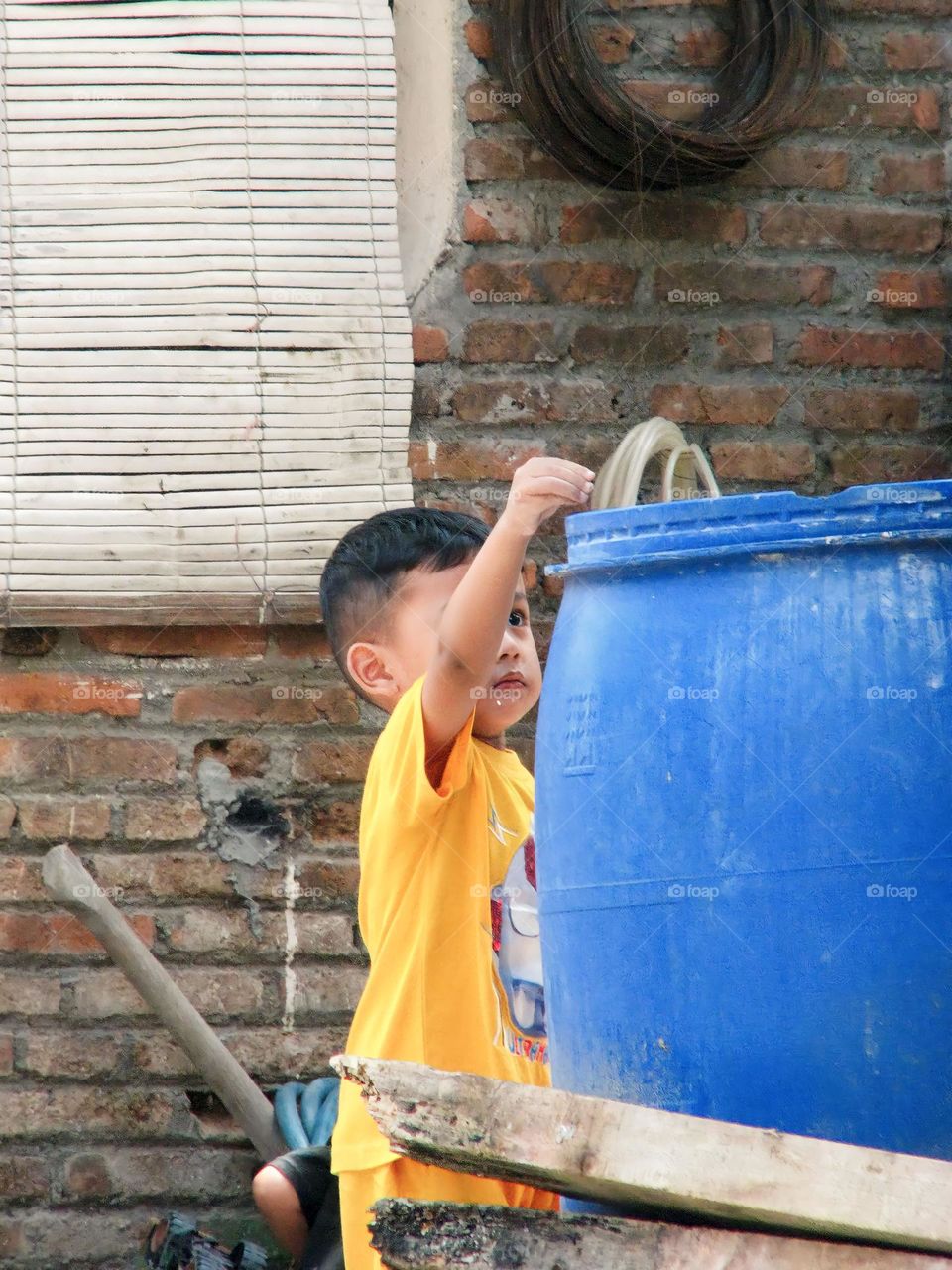 Semarang, Central Java, Indonesia - December 12, 2023: a boy in a hat with a brush