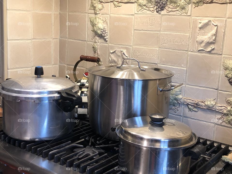 3 pots on the stove cooking dinner for the family