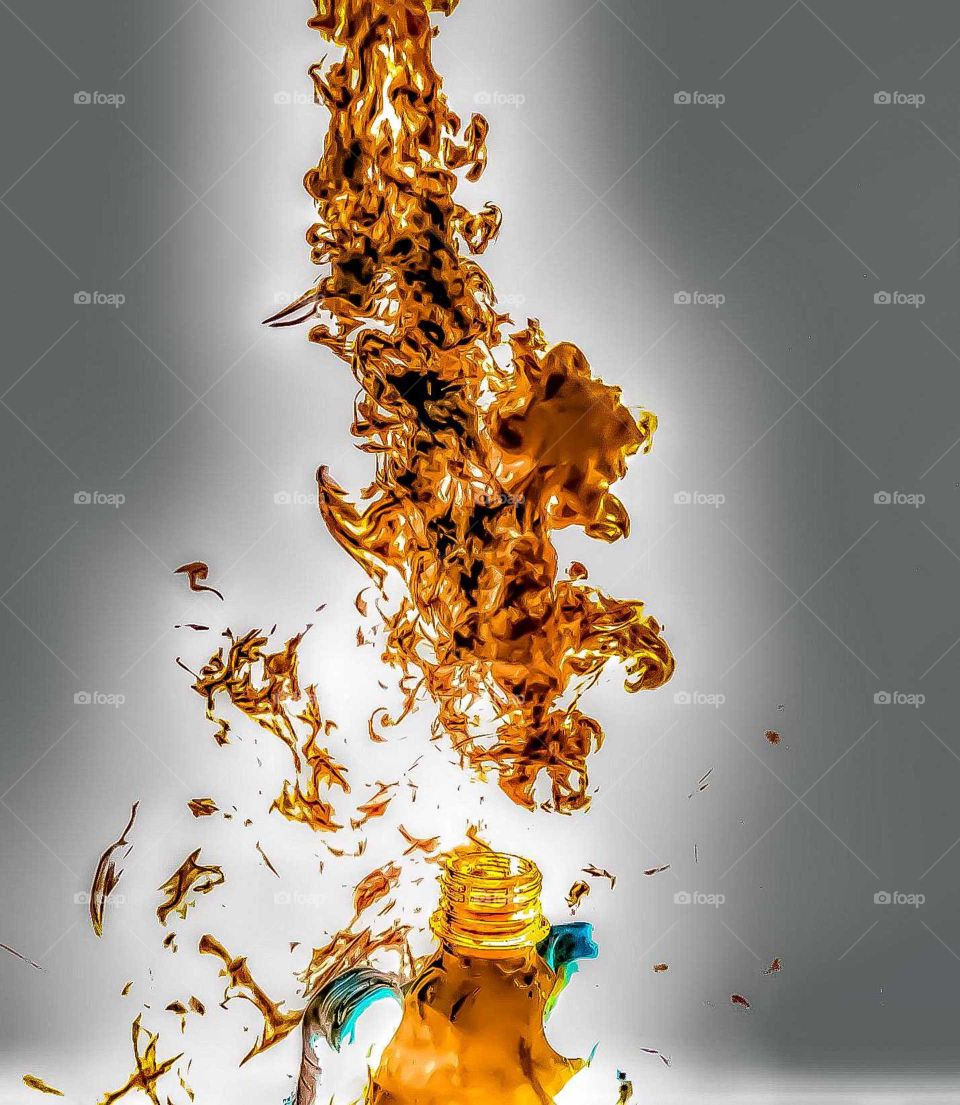 fire or ice? inverted colors of dry ice in water being squeezed out of a water bottle.