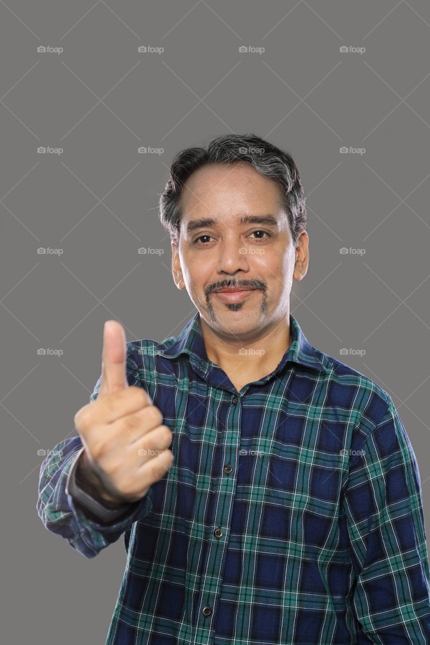 Happy Indian man showing thumbs up