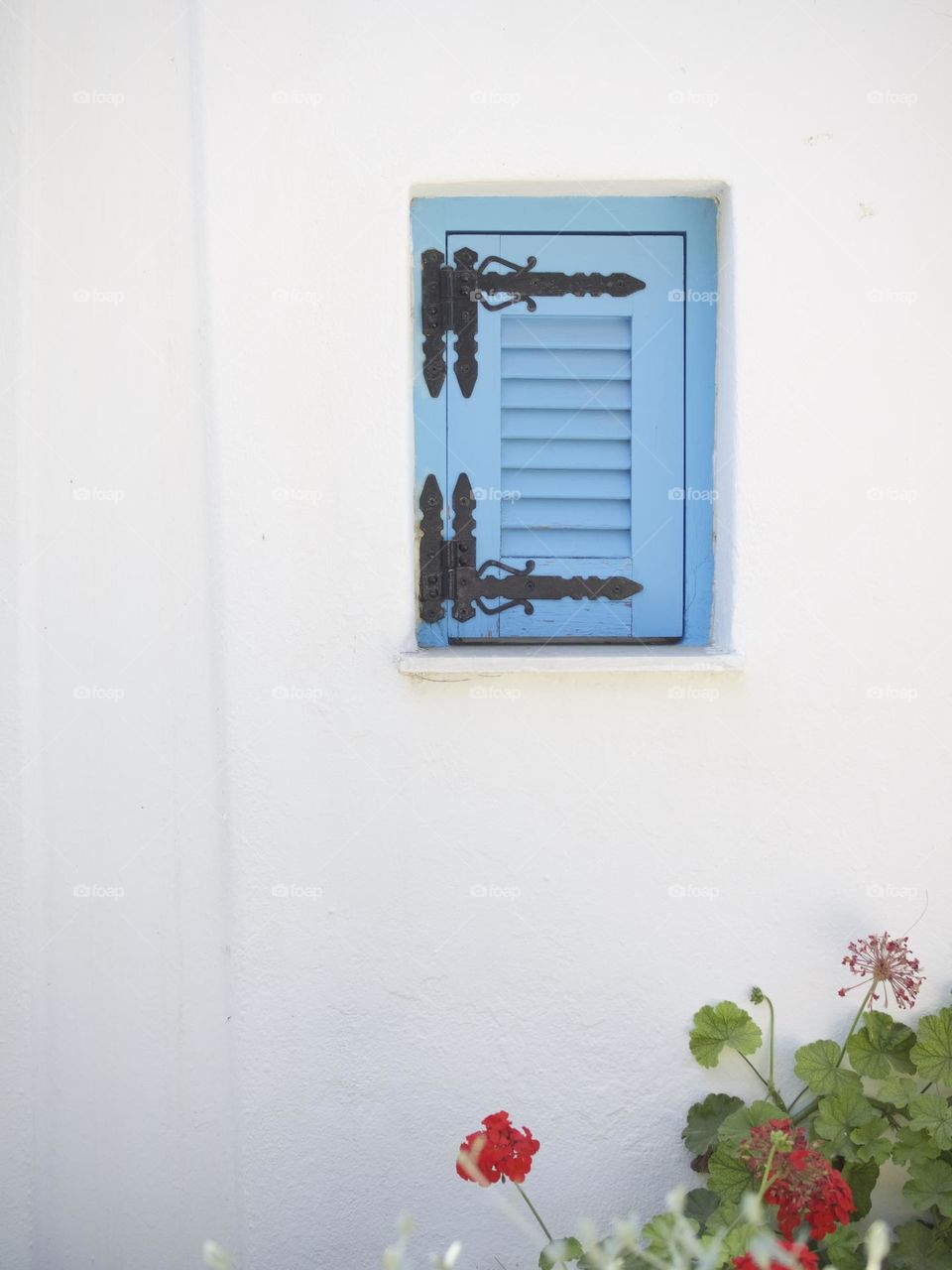 Baby blue architectural detail, Greek island white washed home with blue shutter