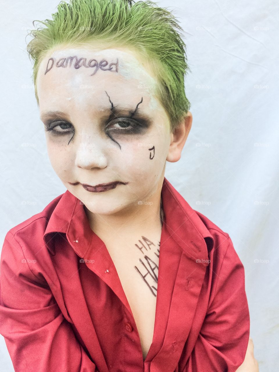 Close-up of boy with damaged text on forehead