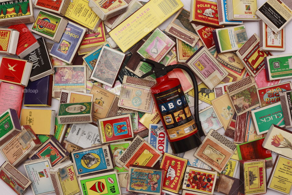 a fire extinguisher and matchboxes