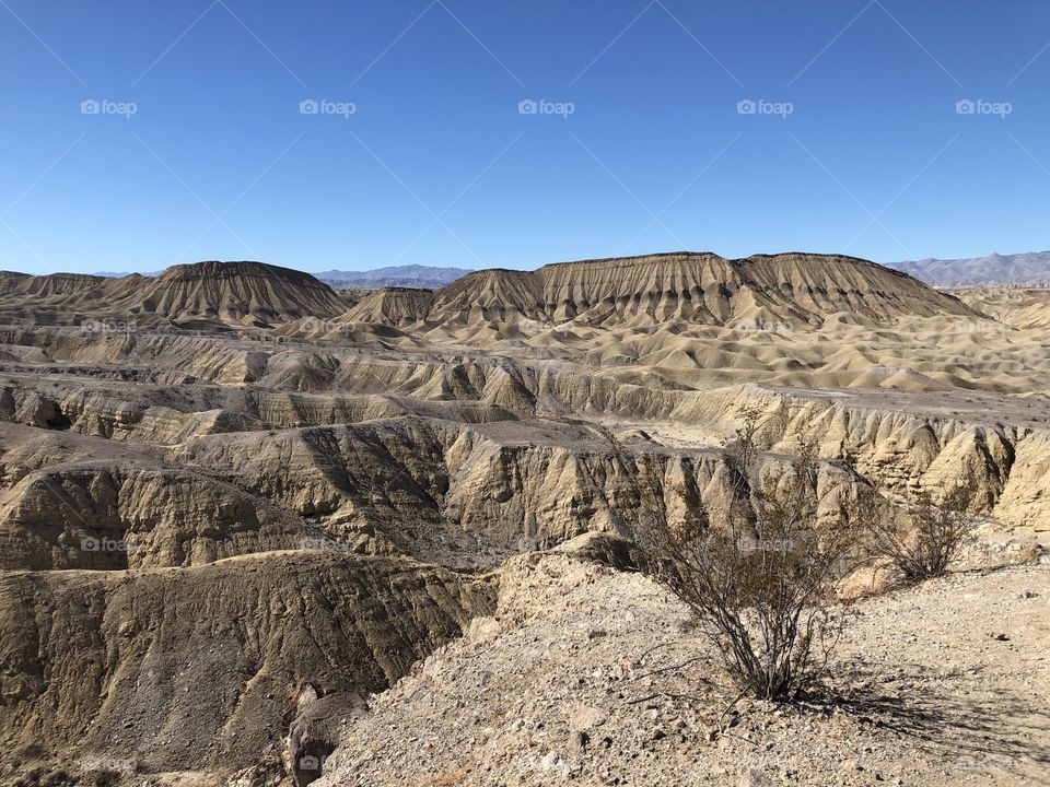 Elephant Knees Mountain in Anza Borrego Desert Park with arid  wasteland foreground hills and blue sky