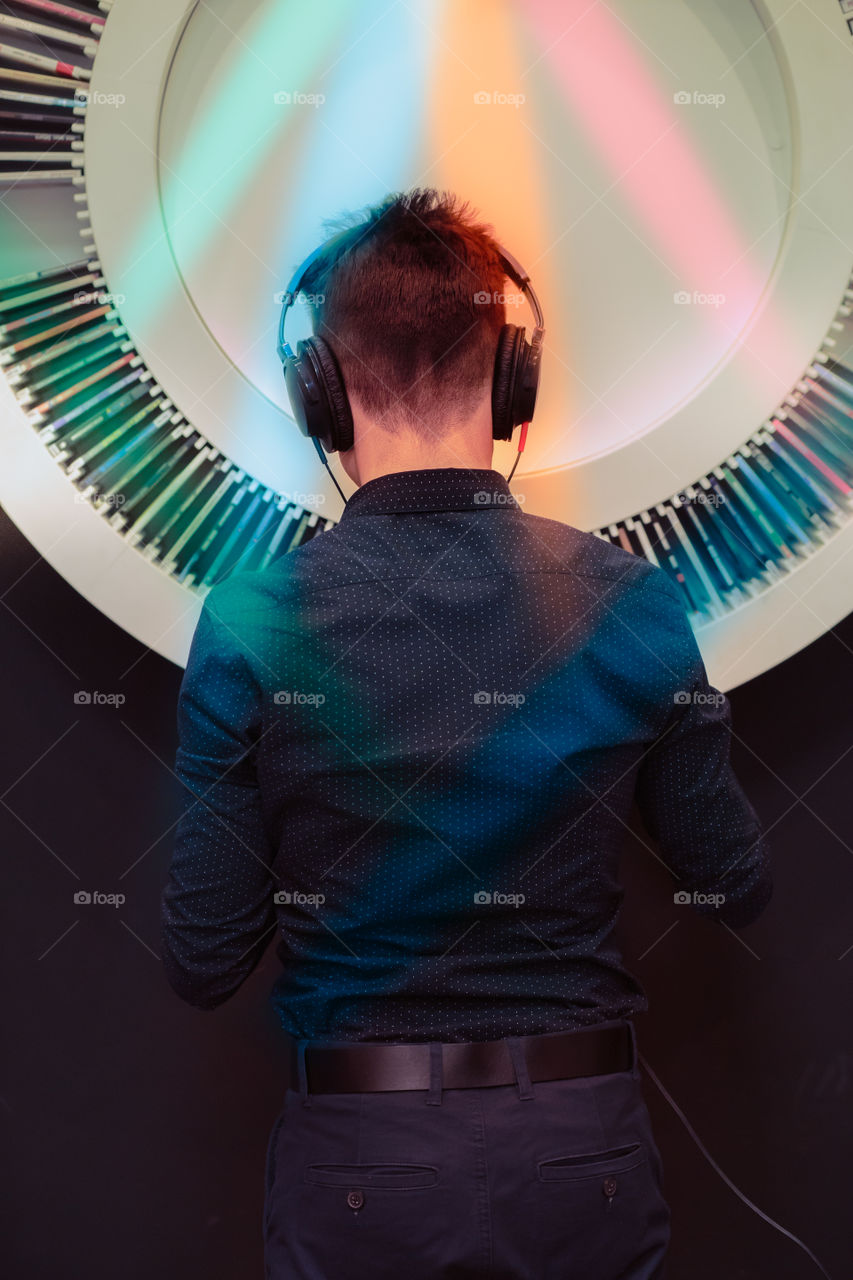 Young man fan of music listening to music through headphones