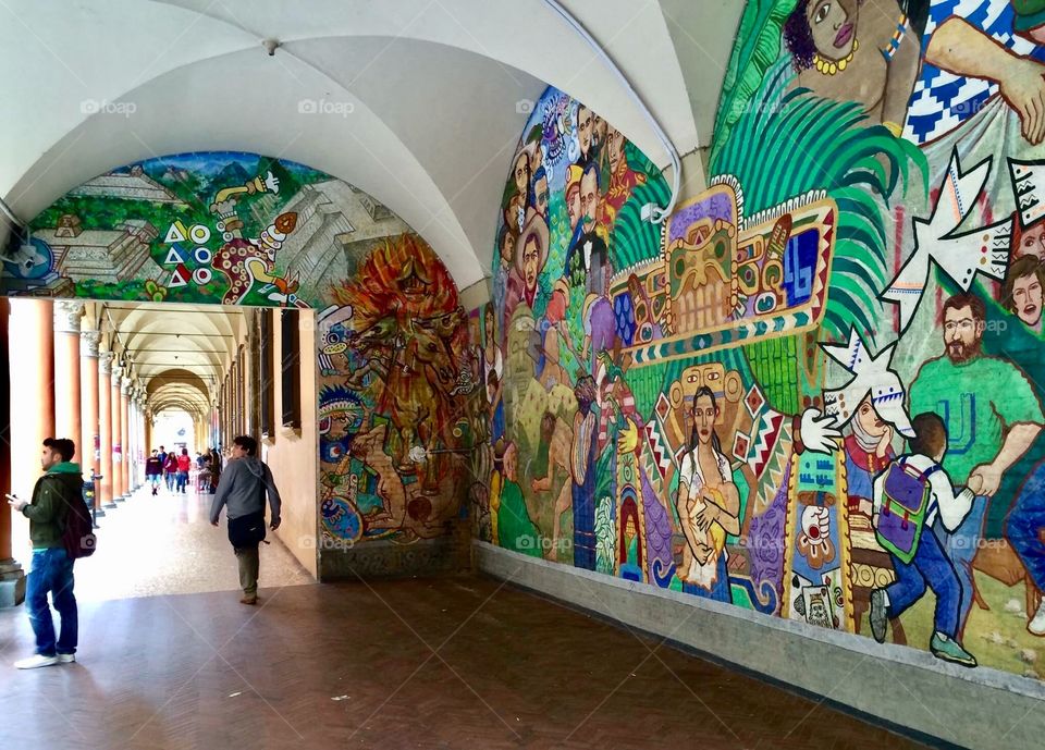 Artwork, graffiti and mural in the university district of Bologna, Italy. Archways and walkways. 