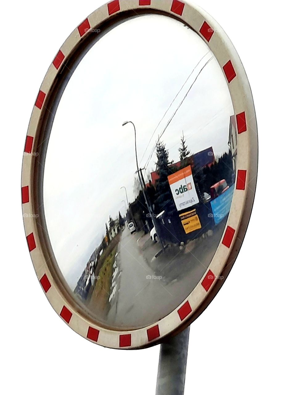 road mirror showing side road at countryside