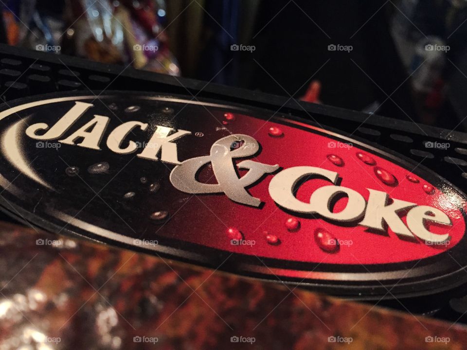 Jack and Coke signage in a bar. Close up of a Jack and Coke signage in a bar.