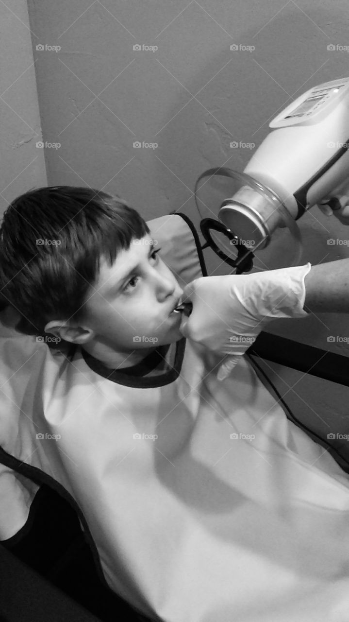 boy getting teeth xrayed at the dentist