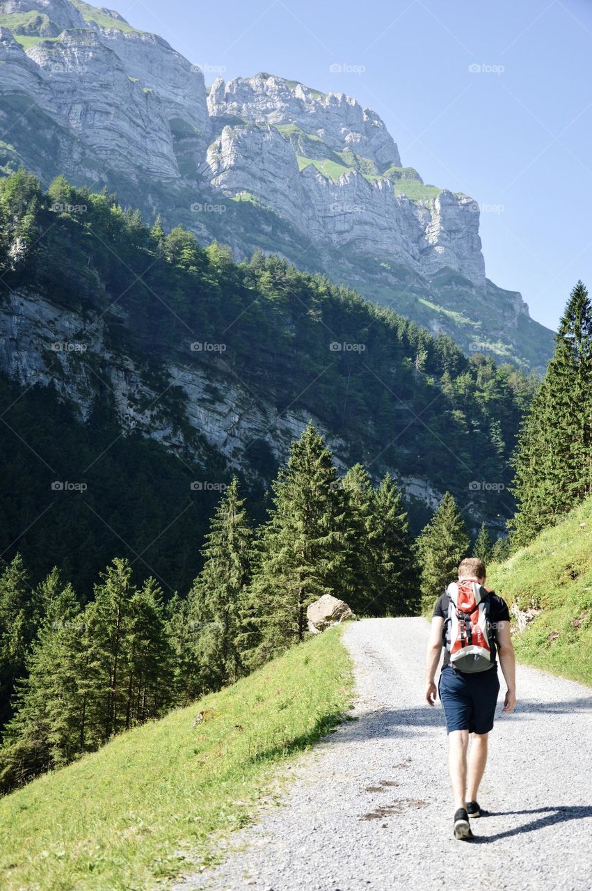 Photo of a man walking in the mountains