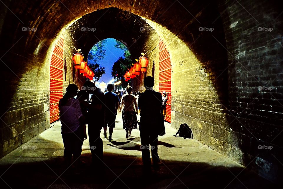 Under the city walls . An evening stroll through a tunnel under Xi'an's city walls.