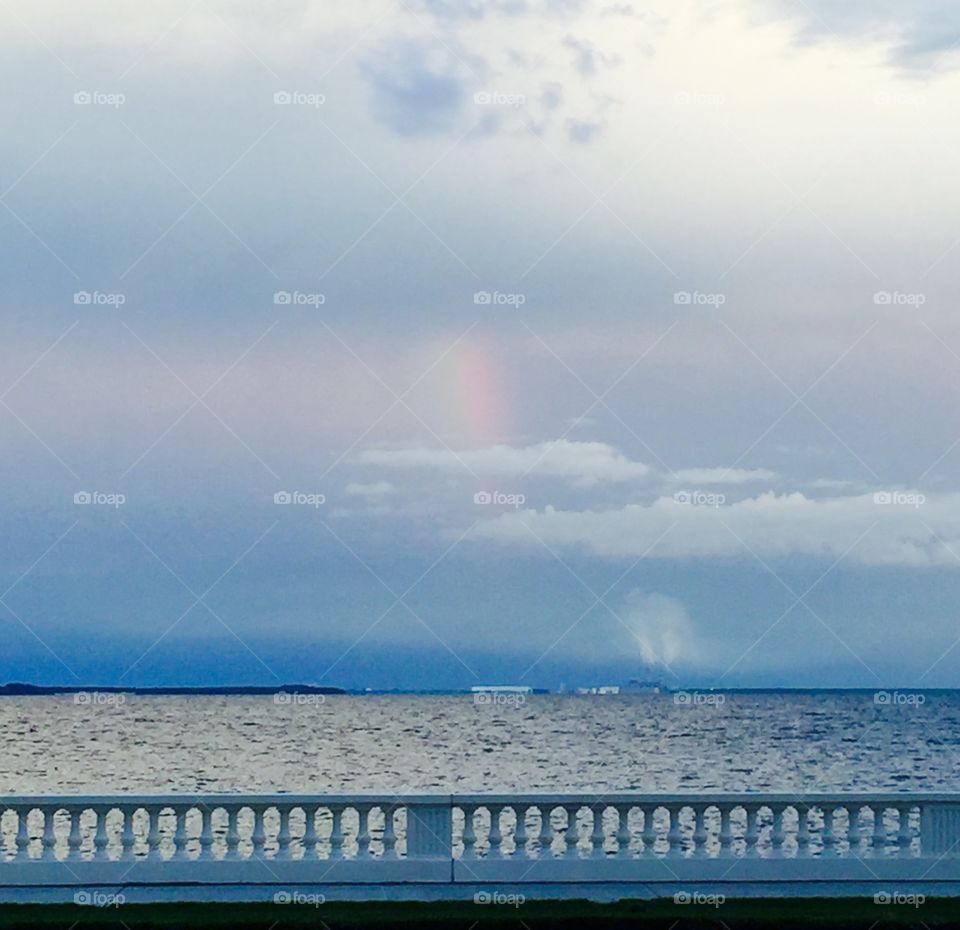 Rainbow over the bay at sunset