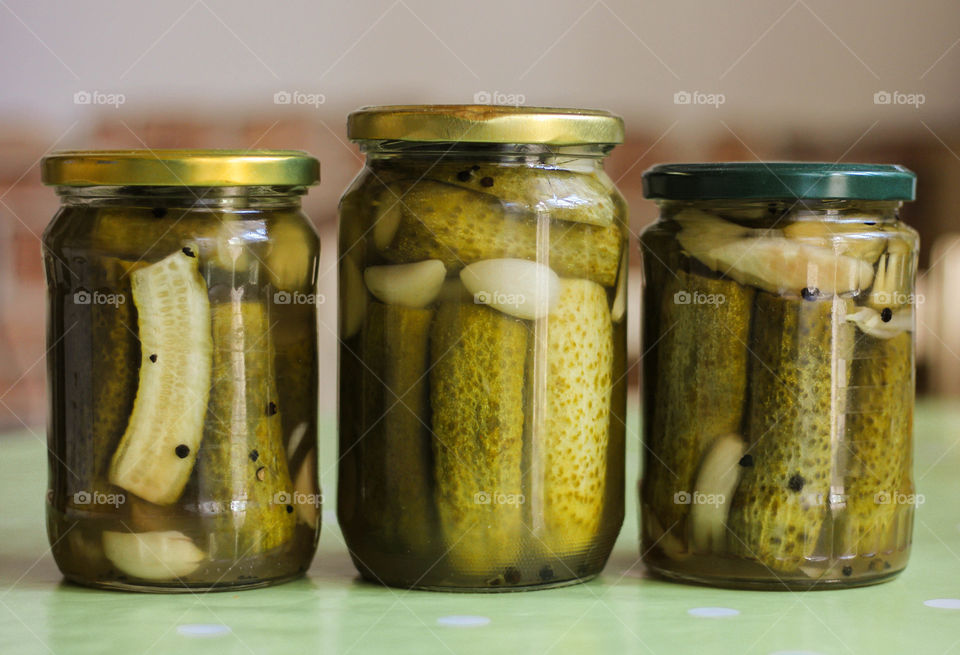 Cucumbers and garlic in jars, pickle for winter