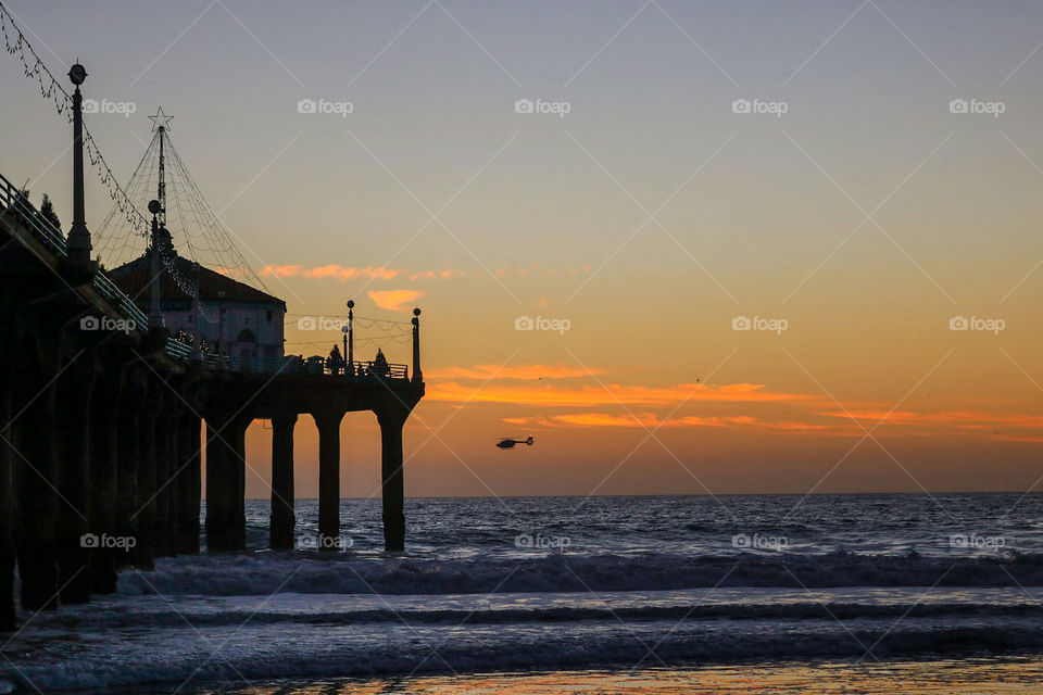 Helicopter fly by at Sunset.  Manhattan Beach, CA
