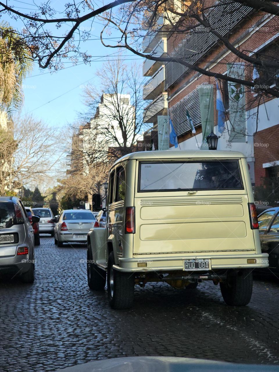 On a cobblestone street, drivers, commuters, head forward