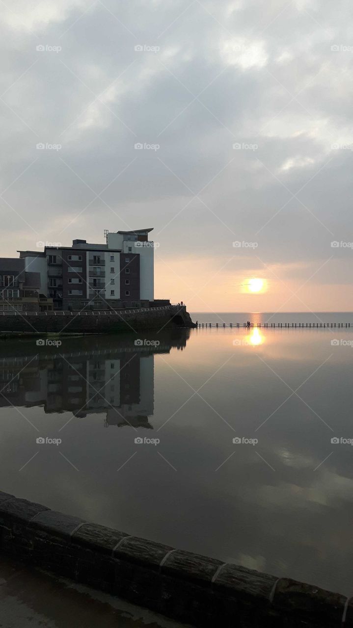 knightstone island with reflection on water. With a beautiful sunset