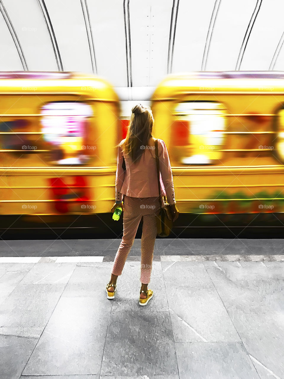 Young woman waiting for a train at the subway station 