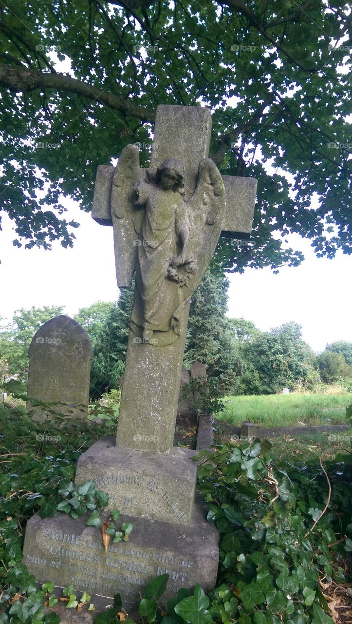 angel on cross in graveyard