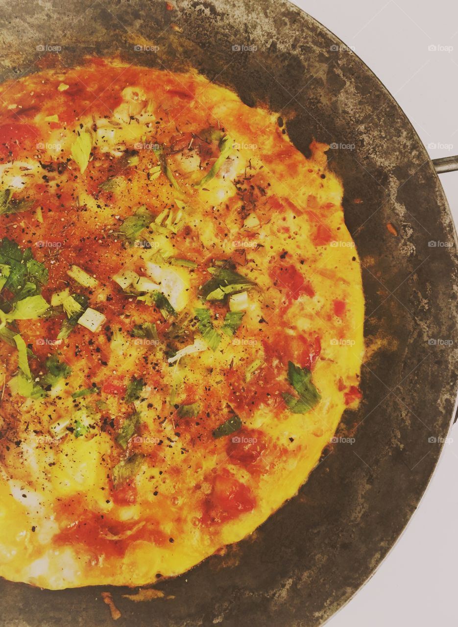 Breakfast. Tomatoe omelette in the pan, top view