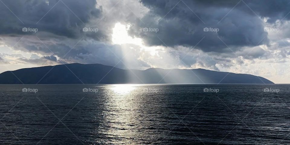 Incredible view of the sea illuminated by the rays of the sun