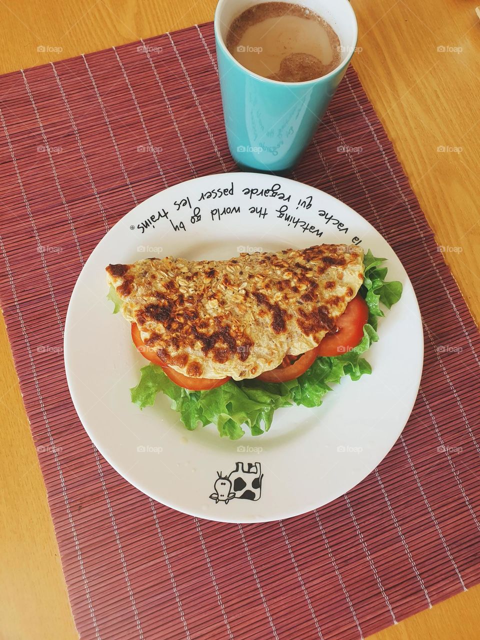 Colorful breakfast with oat pancake and tomato.