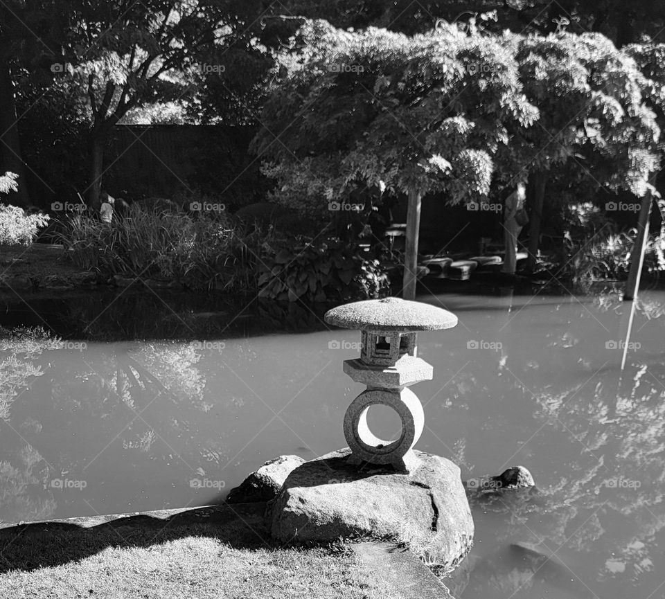 a statue located at a Japanese zen garden in the city