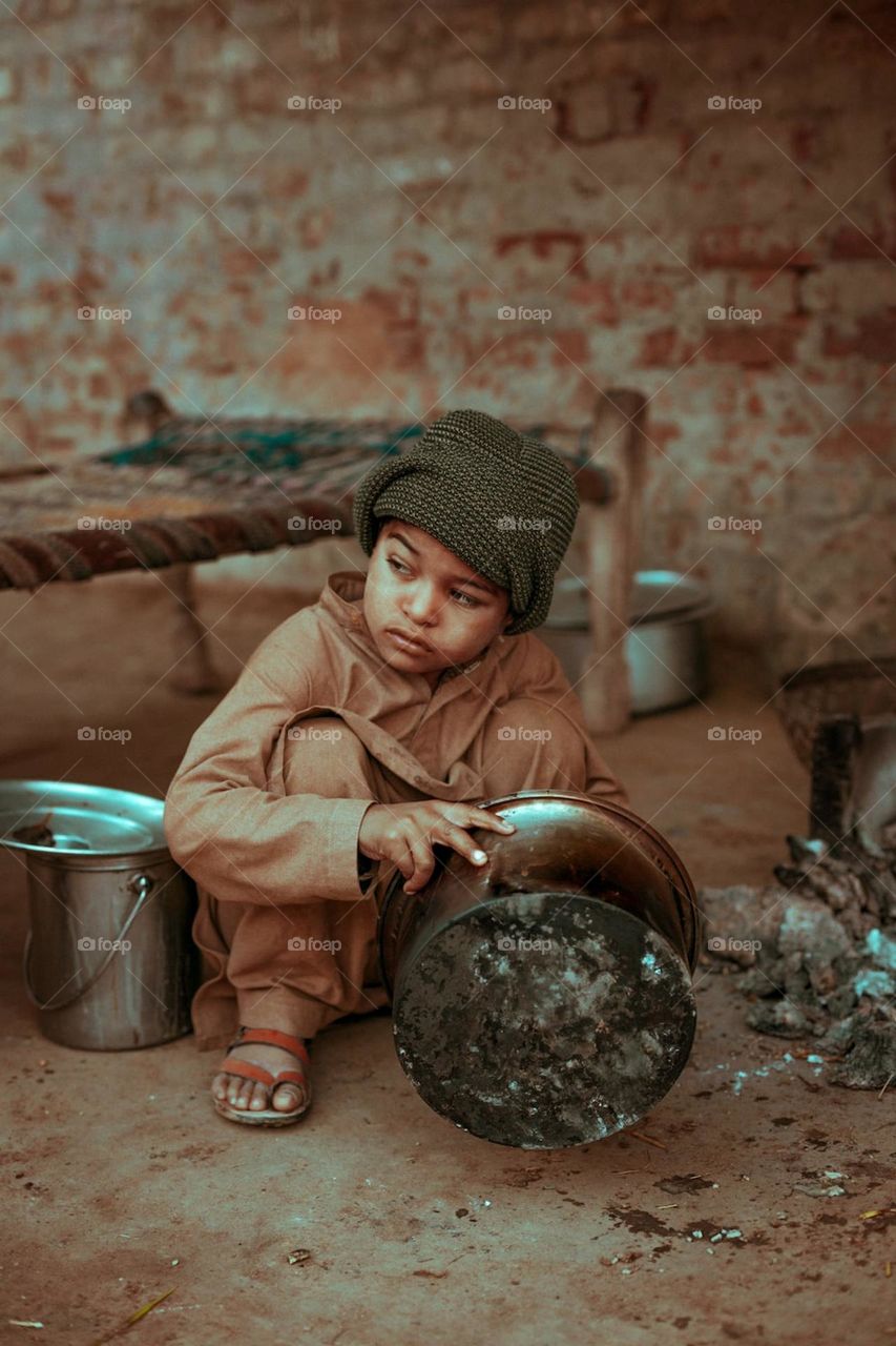 In this photo it is told that a boy who is without parents and is cooking food from his own memories.