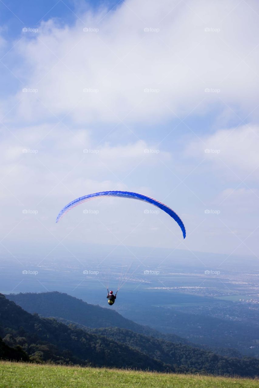 man with parachute near mountain and village.. 😍💚