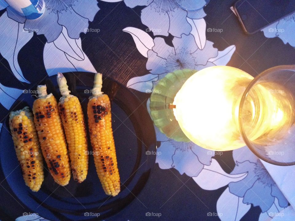 Grilled corn. Grilled Corn beside an ancient lights at dinner