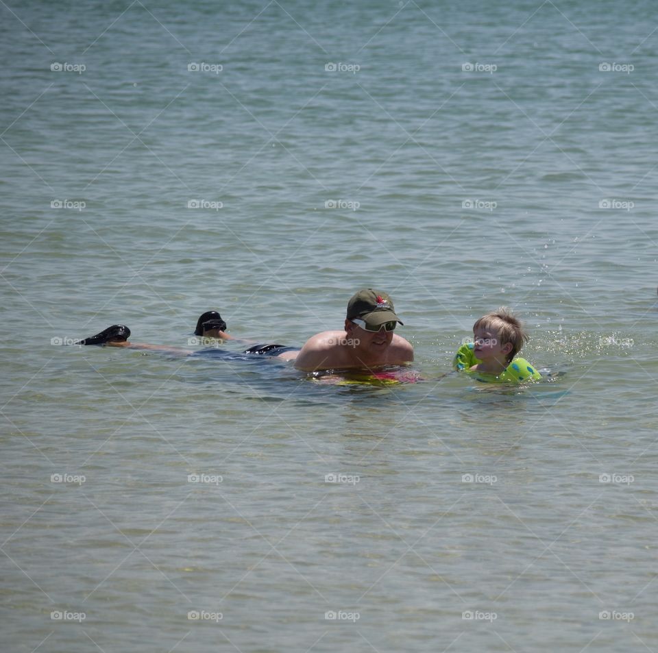 Father and son enjoying in sea