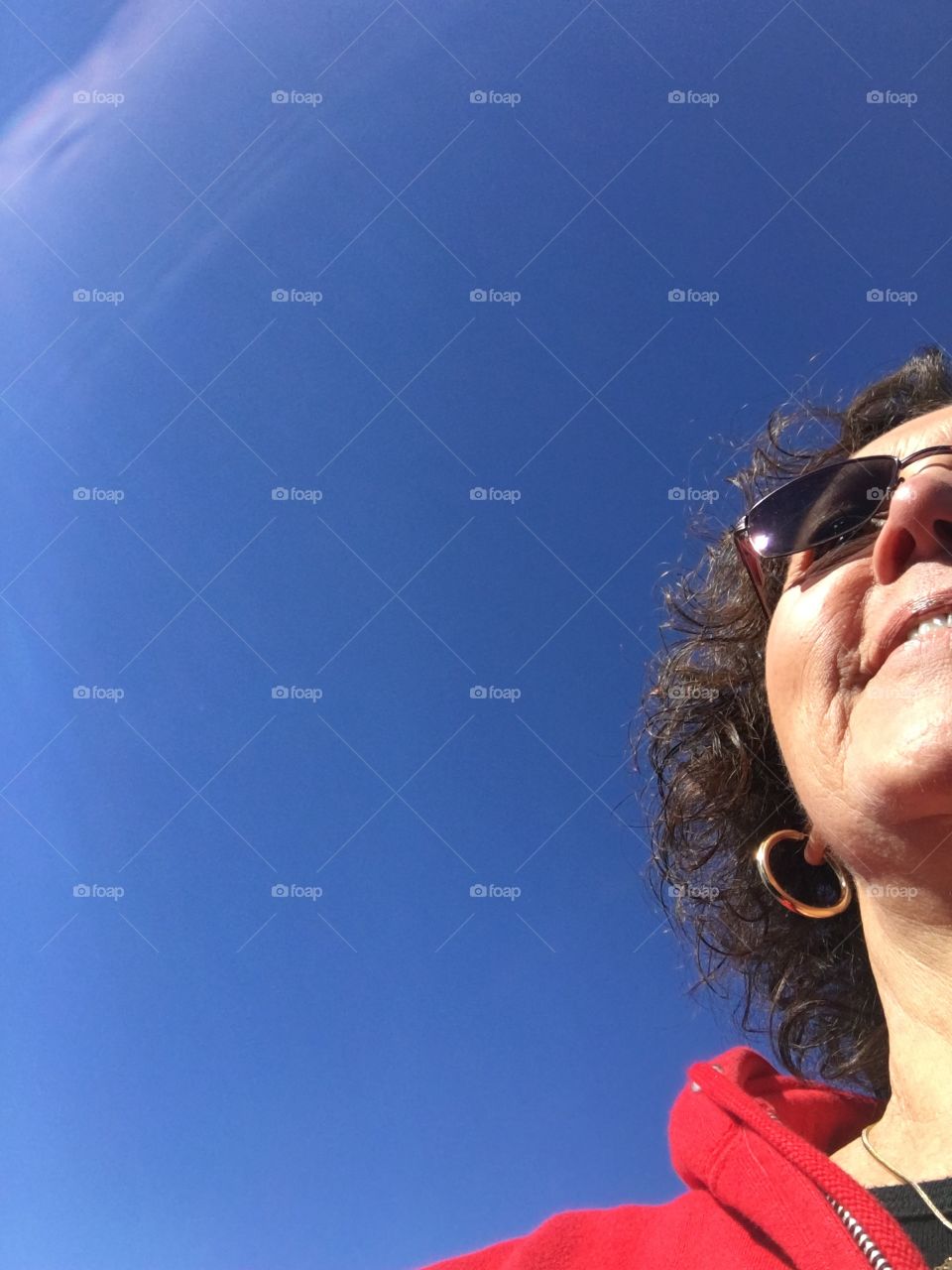 Selfie by mistake, going forward on sunny day. Blue sky, whispy cloud.