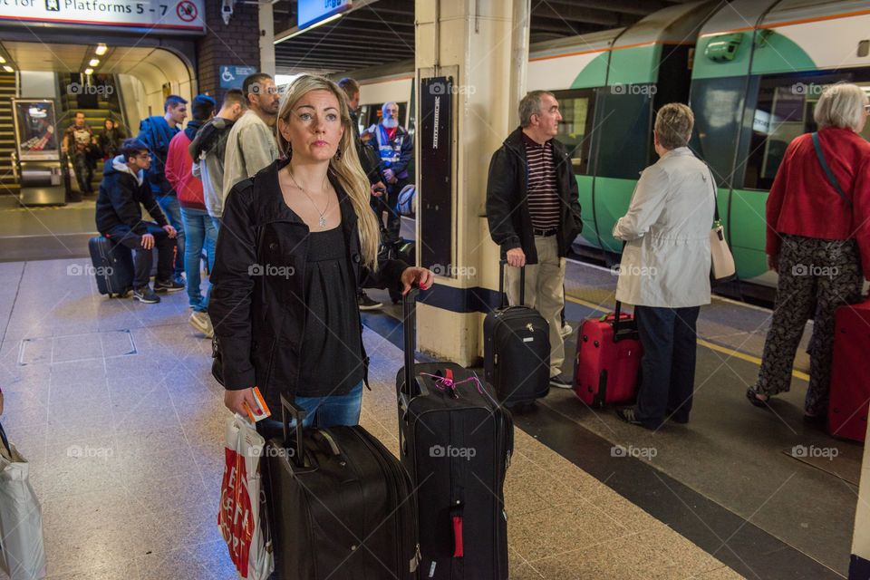 Swedish tourist trying to read all the signs to tak the train from Gatwick airport to London.