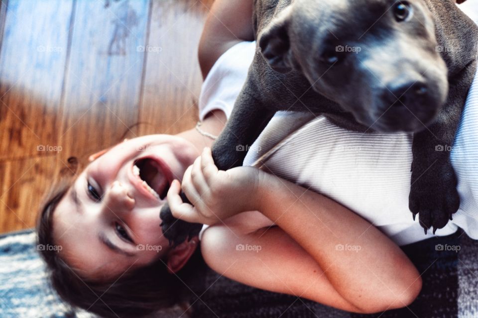 Close-up of a girl playing with her dog