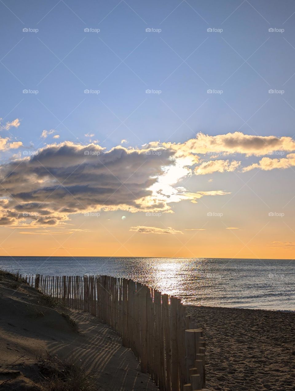 Sun behind clouds at beach