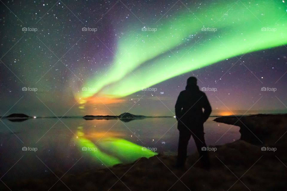 beautiful northern lights over iceland, mirror effect, vacation goals