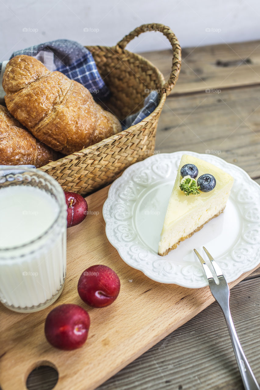 Croissants with milk, fruits and dessert