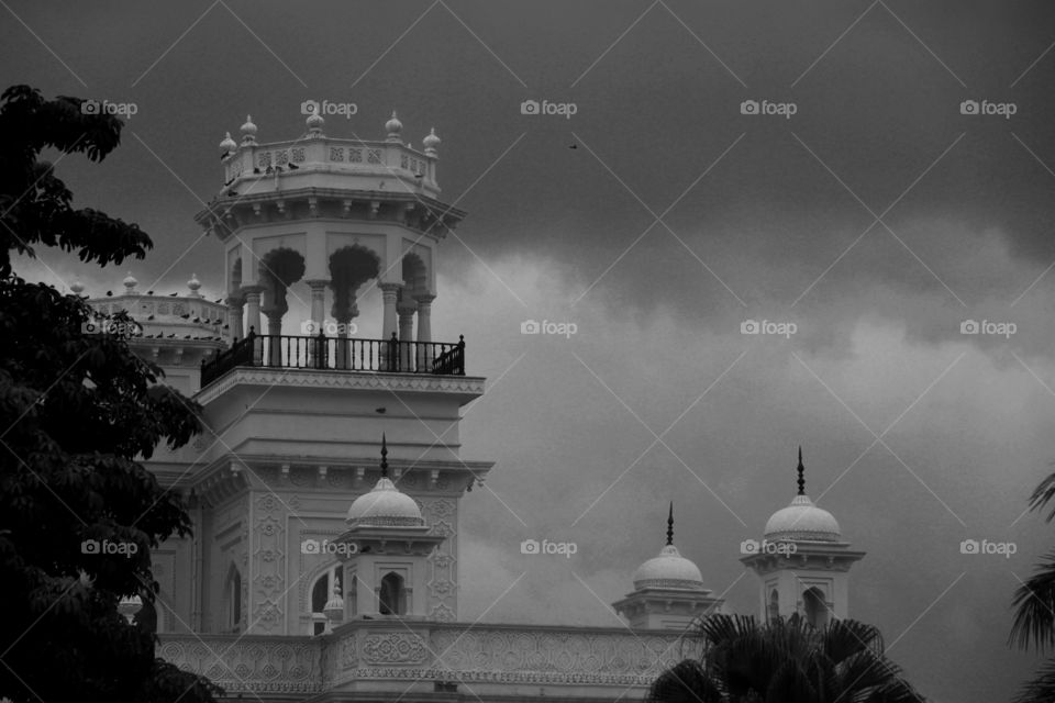 Black and white view of assembly in a cloudy sky